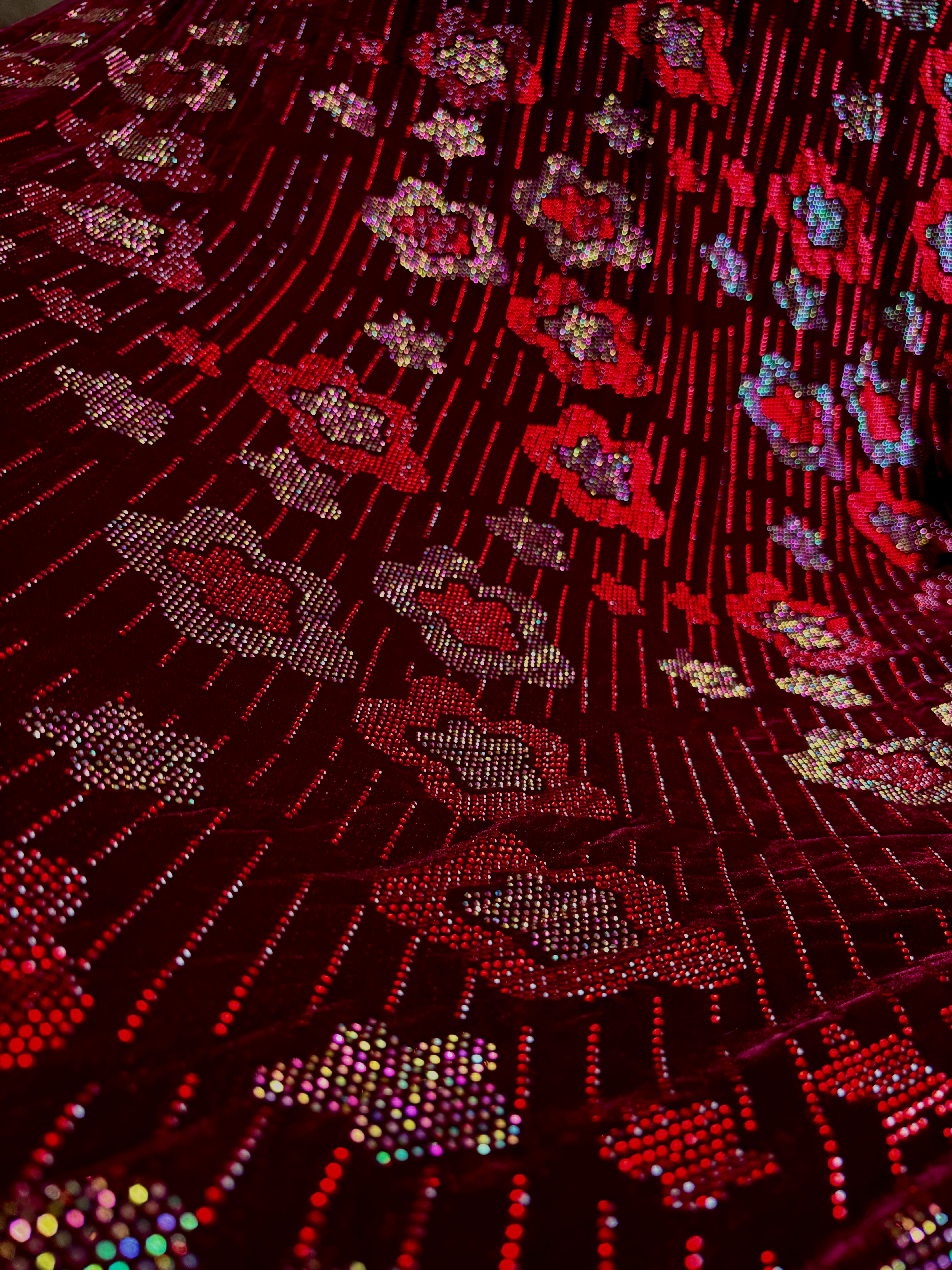 Red velvet floral fabric suit by Stretch Velvet featuring a rich velvet texture and vibrant floral pattern.
