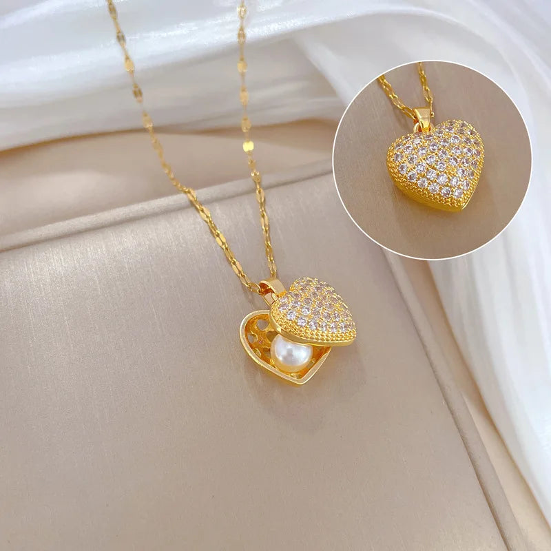 ZAKOL gold-colored stainless steel shell pearl necklace with love heart pendant, perfect for womenโs wedding or casual jewelry.