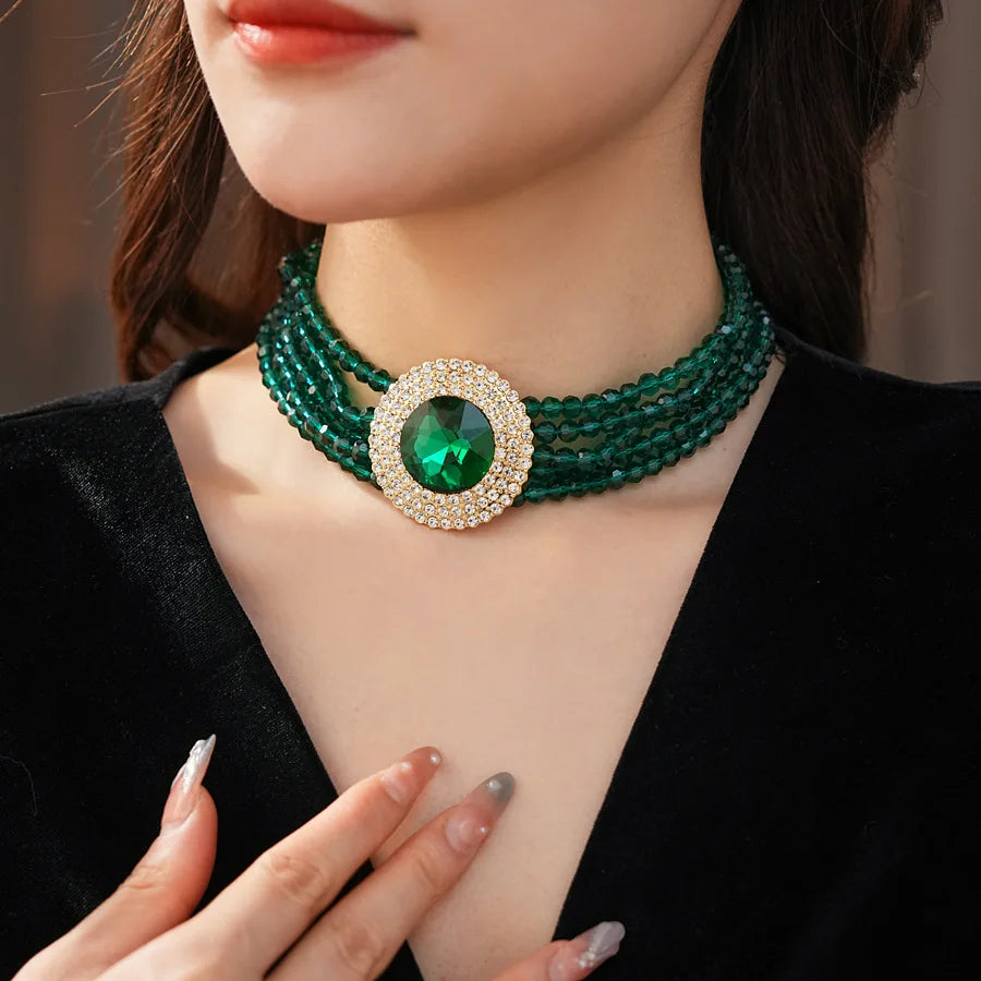 Elegant green jewelry set by MC THE BLACK DIAMOND with rhinestone accents, includes necklace and earrings for women.