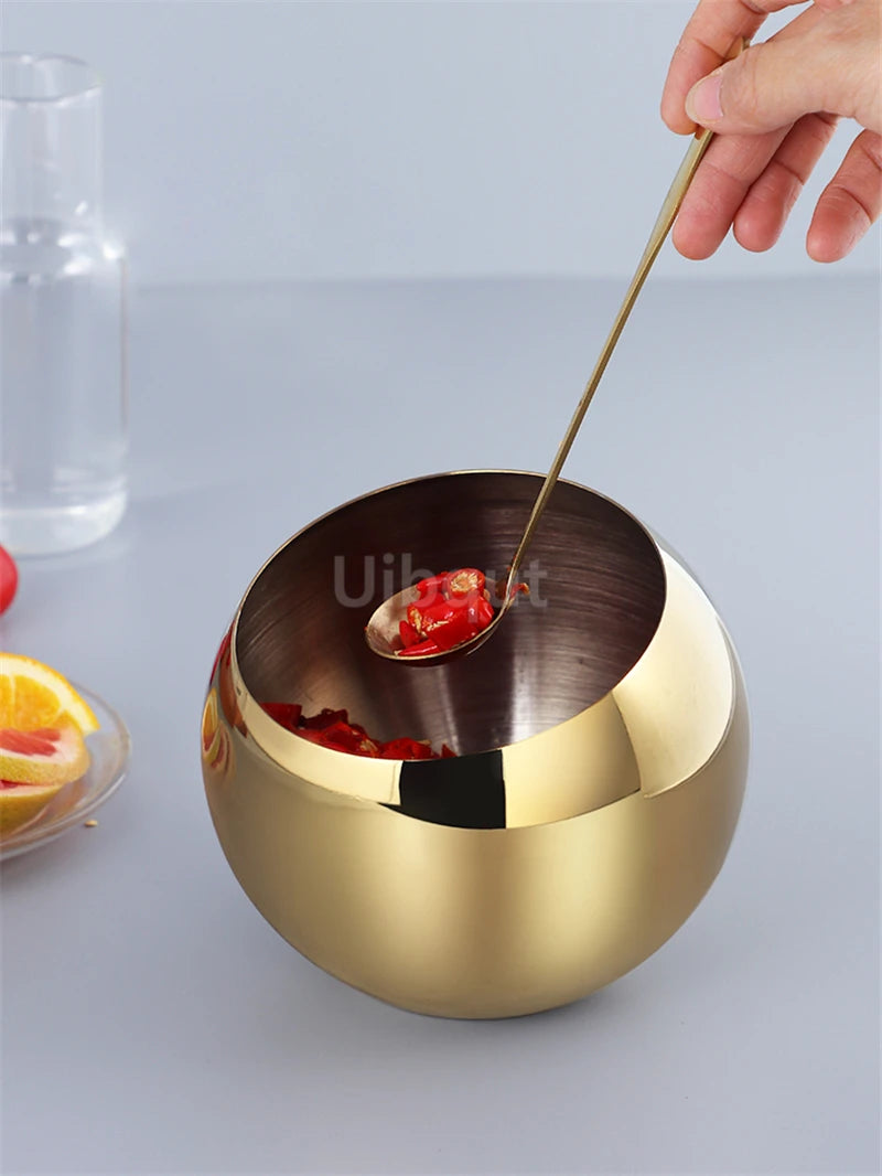 Stainless steel oblique-mouthed sauce bowl with lid, perfect for hot pots, salads, and seasoning at a kitchen buffet setting.
