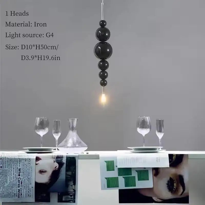 Black chandelier by MC THE BLACK DIAMOND with tear-shaped design, hanging from ceiling, ideal for luxury living rooms and dining areas.