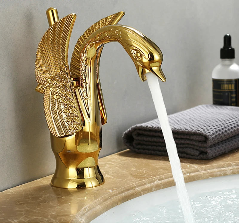 MC THE BLACK DIAMOND golden basin deck mount sink faucet with swan-shaped single handle for hot and cold water.
