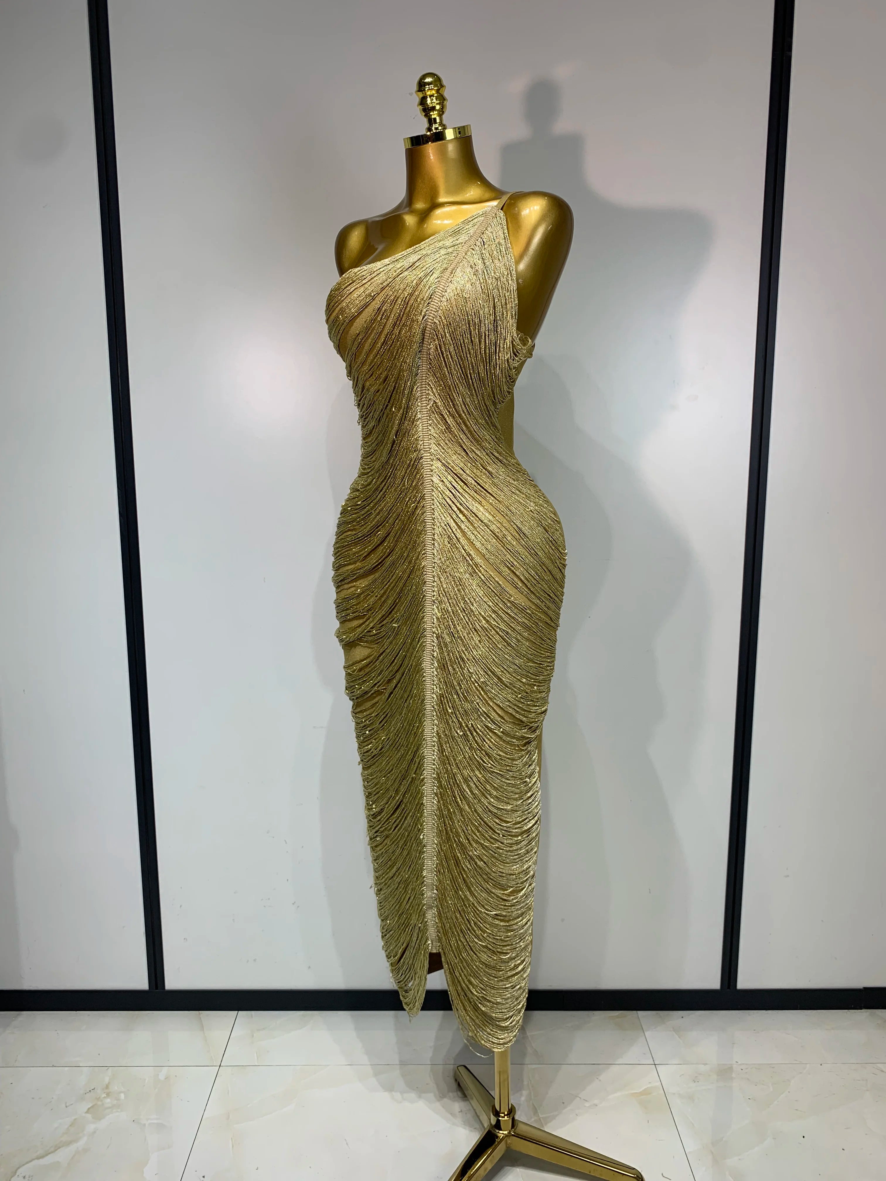 MC Women backless gold bodycon bandage dress with tassel details, featuring a sleek, fitted design perfect for evening wear.