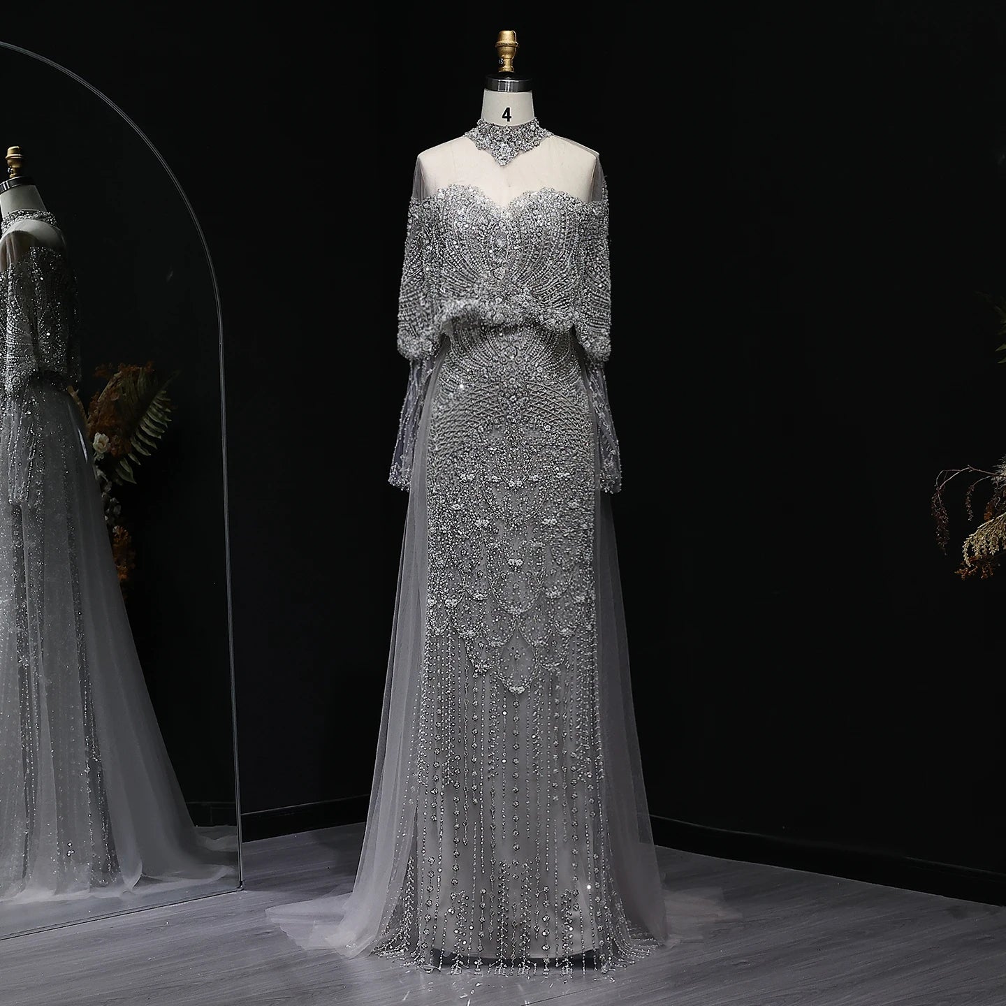 Beaded grey Arabic evening dress by MC THE BLACK DIAMOND featuring intricate beadwork and elegant flowing design.
