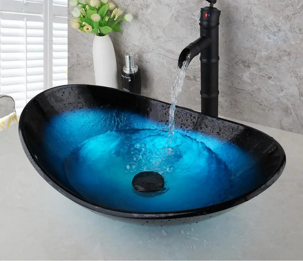 MC THE BLACK DIAMOND ZAPPO tempered glass bathroom vessel sink with blue oval basin and black waterfall faucet tap.