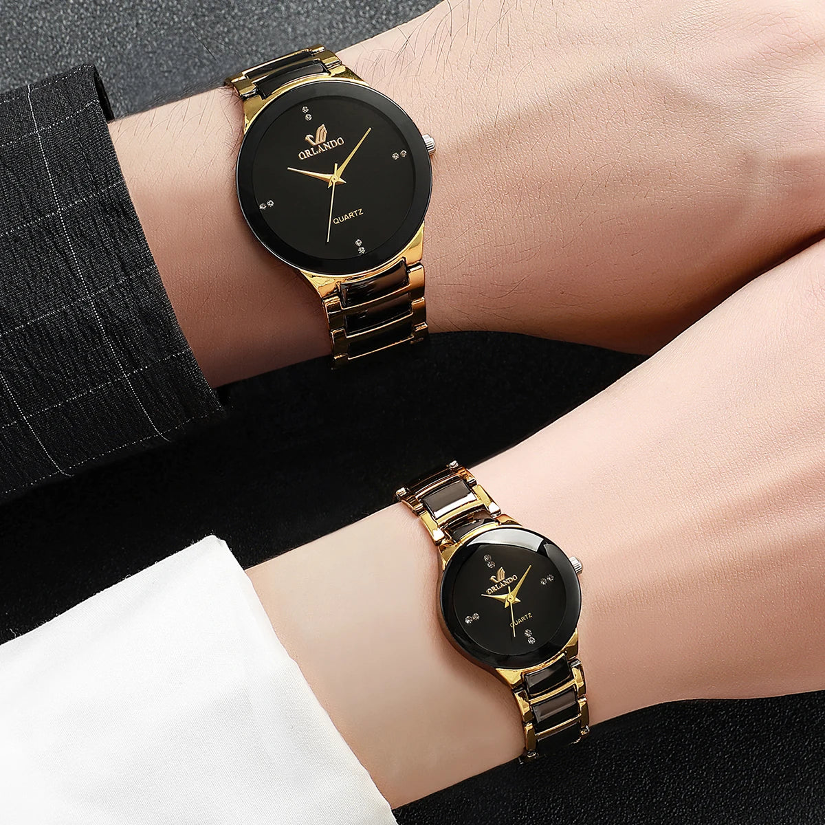 Matching couple's watches by MC The Black Diamonds, black and silver tones, sleek design, with round dial and metal band.