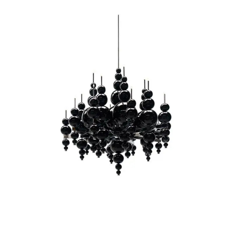 Black chandelier by MC THE BLACK DIAMOND featuring tear-shaped moon design, hanging from ceiling in a luxurious living room setting.