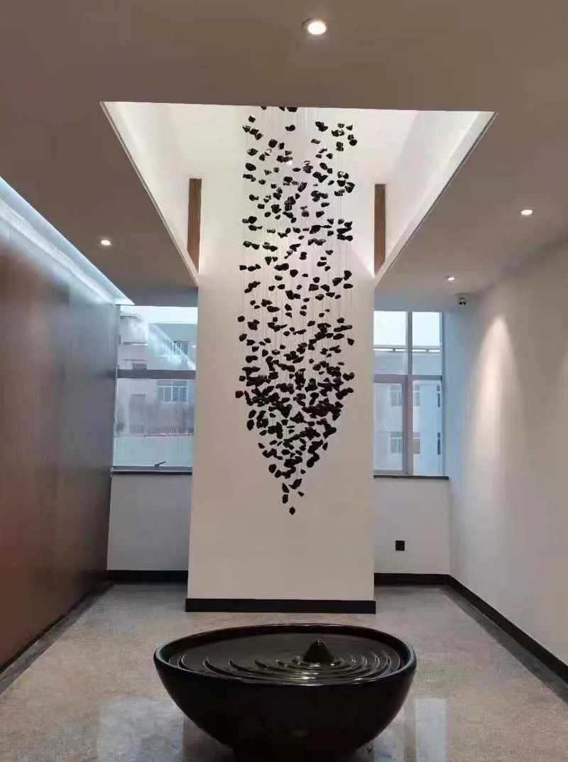 Black Art Luxury Stone Crystal Chandelier by MC THE BLACK DIAMOND with LED lights, hanging in modern staircase or hallway setting.