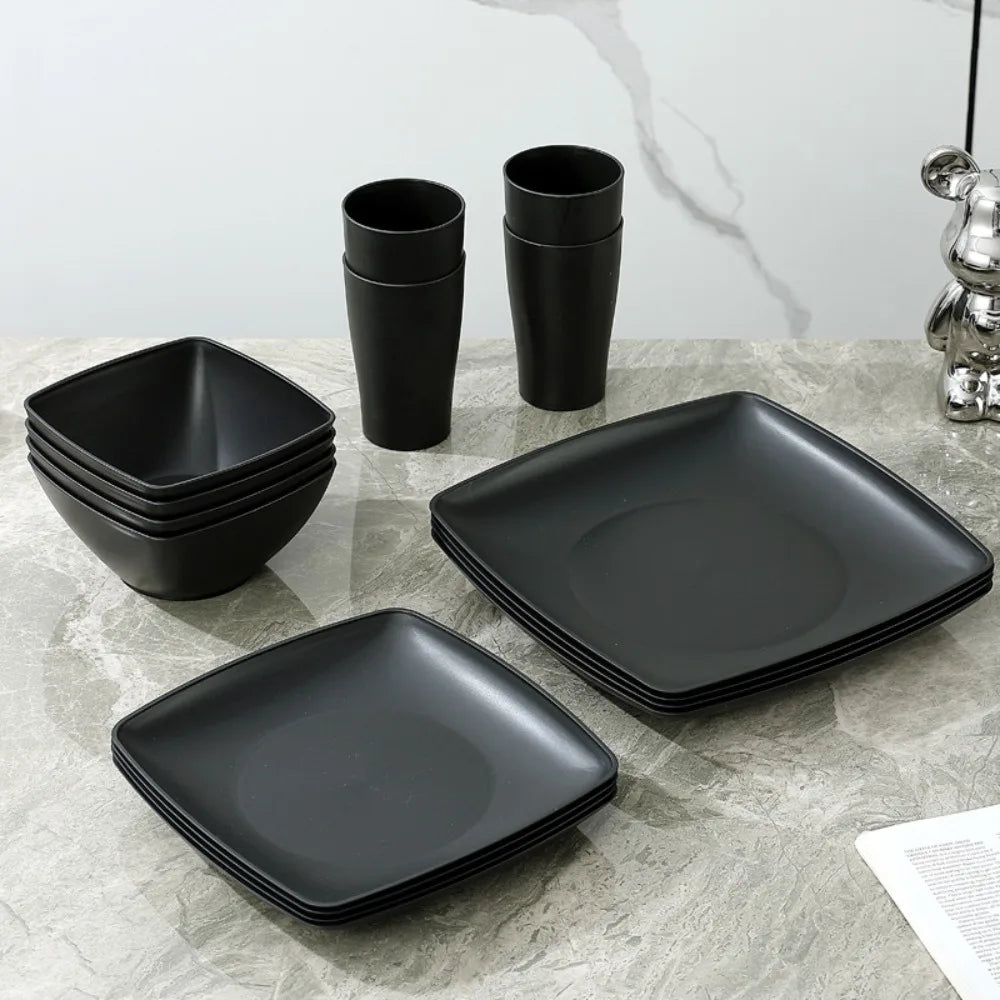 Set of 16 plastic square dinnerware pieces from MC The Black Diamonds kitchen collection, including plates and bowls.