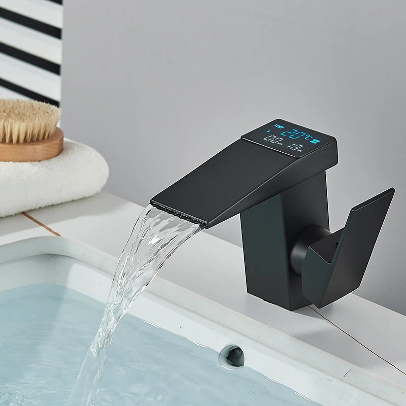 Digital display basin sink faucet by MC The Black Diamonds with LED temperature indicator and waterfall spout in bathroom decor.