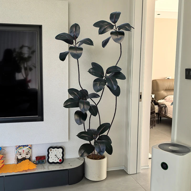 Artificial green rubber tree plant with black and gold accents, showcasing lush foliage and realistic details.