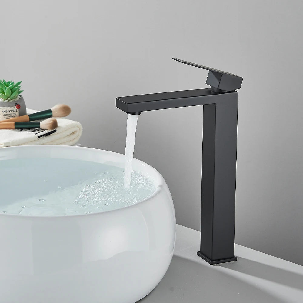 Matte black stainless steel bathroom sink faucet with hot and cold handles, deck-mounted waterfall mixer tap by ๐๐ ๐๐๐ ๐น๐๐๐๐ ๐ป๐