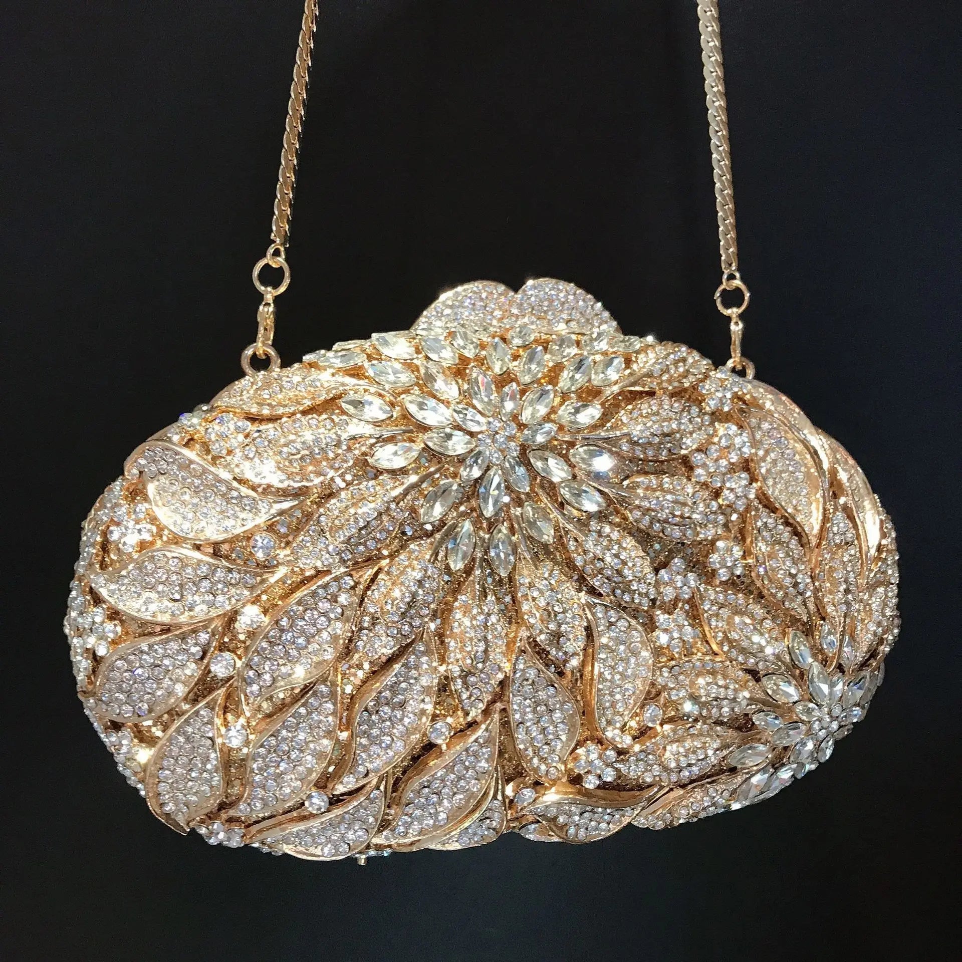 Gold metal leaves and white crystal evening clutch bag by MC THE BLACK DIAMOND featuring rhinestones and mini heart design for women.