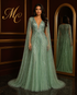 Turquoise mermaid evening dress by MC THE BLACK DIAMOND featuring flowing fabric and elegant design for formal occasions.