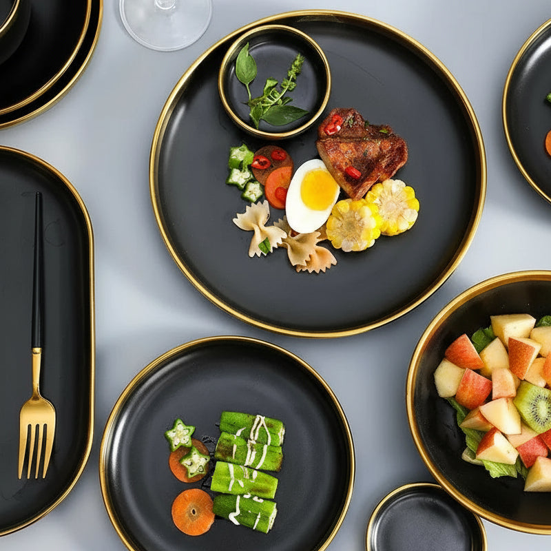 Set of matte gold inlay black porcelain dinnerware featuring elegant plates and bowls from MC THE BLACK DIAMOND kitchen collection.