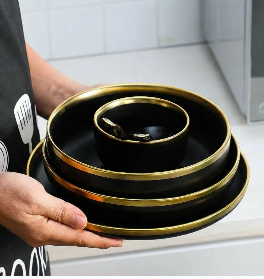 Set of matte gold inlay black porcelain dinnerware by MC THE BLACK DIAMOND, featuring elegant kitchen dinner sets with matching plates and bowls.