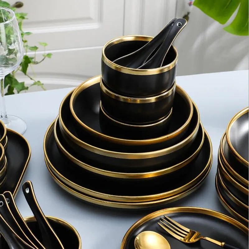 Set of matte gold inlay black porcelain dinnerware by MC THE BLACK DIAMOND, includes plates and bowls for elegant dining.