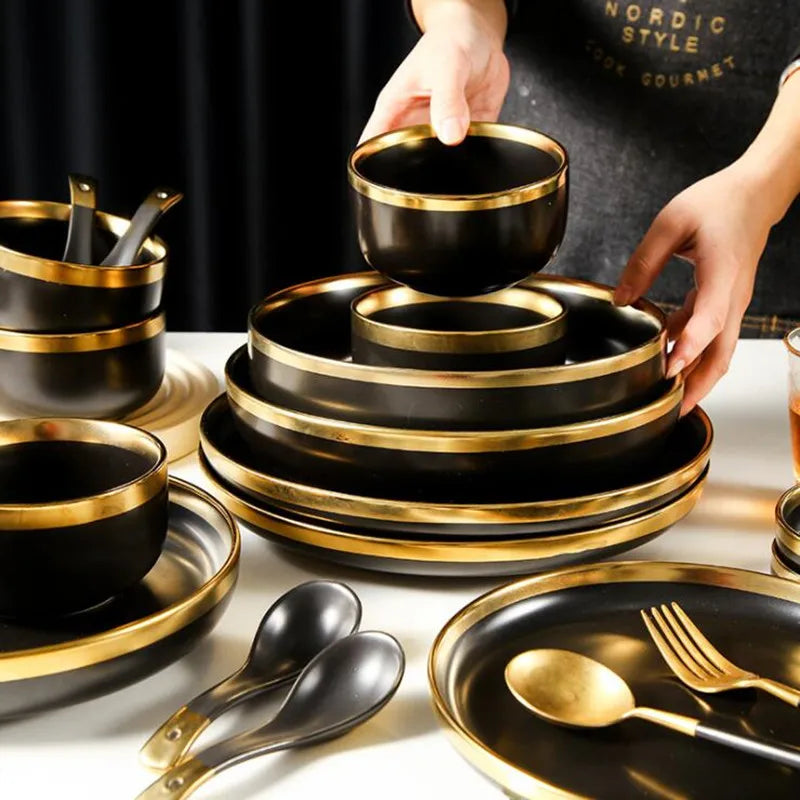 Set of matte gold inlay black porcelain dinnerware by MC THE BLACK DIAMOND, including plates and bowls for elegant kitchen use.
