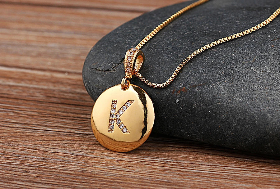 Gold initial letter necklace featuring a CZ charm from Mc The Black Diamonds, with a focus on the letter A-Z pendant design.