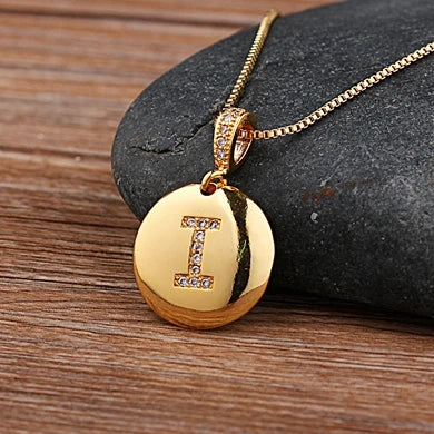 Nidin initial letter necklace for women and girls featuring a copper chain with a CZ charm pendant in the shape of the letter A.