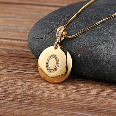 Nidin initial letter necklace featuring a copper chain with CZ charm pendant displaying the letter A, jewelry by 𝕄𝕔 𝕋𝕙𝕖 𝔹𝕝𝕒𝕔𝕜 𝔻𝕚