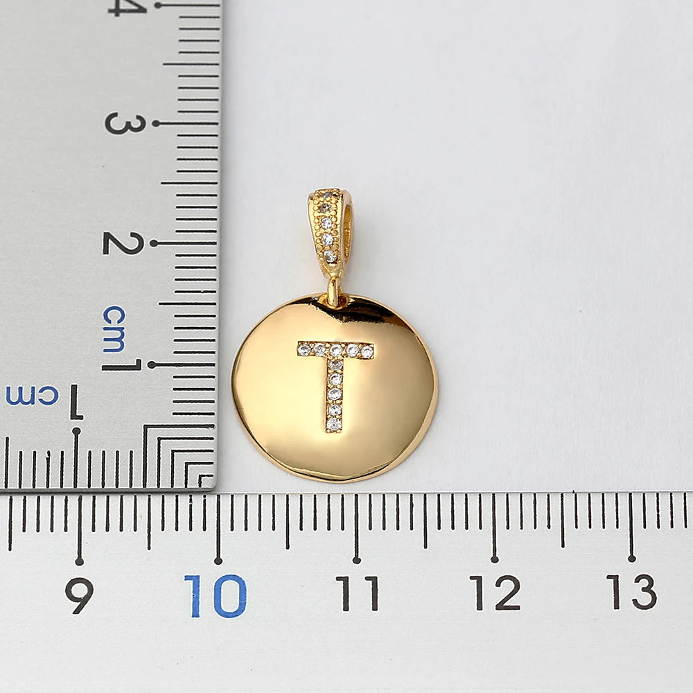 Nidin initial letter necklace featuring a copper pendant with CZ gemstone, showcasing a gold-tone letter charm from 𝕄𝕔 𝕋𝕙𝕖 𝔹𝕝𝕒𝕔𝕜 𝔻𝕚