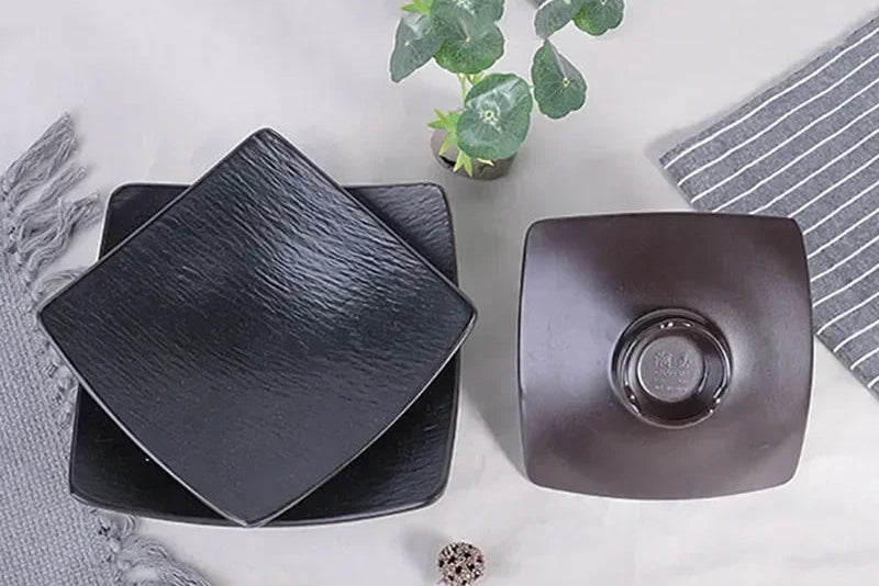Black frosted melamine dinner plate from Mc The Black Diamonds, ideal for sushi, snacks, and fruit in a hotpot restaurant setting.