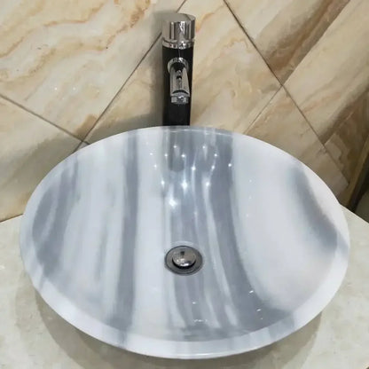 Handmade rose quartz vessel sink for bathroom decor, featuring a smooth, polished pink quartz bowl with elegant design.