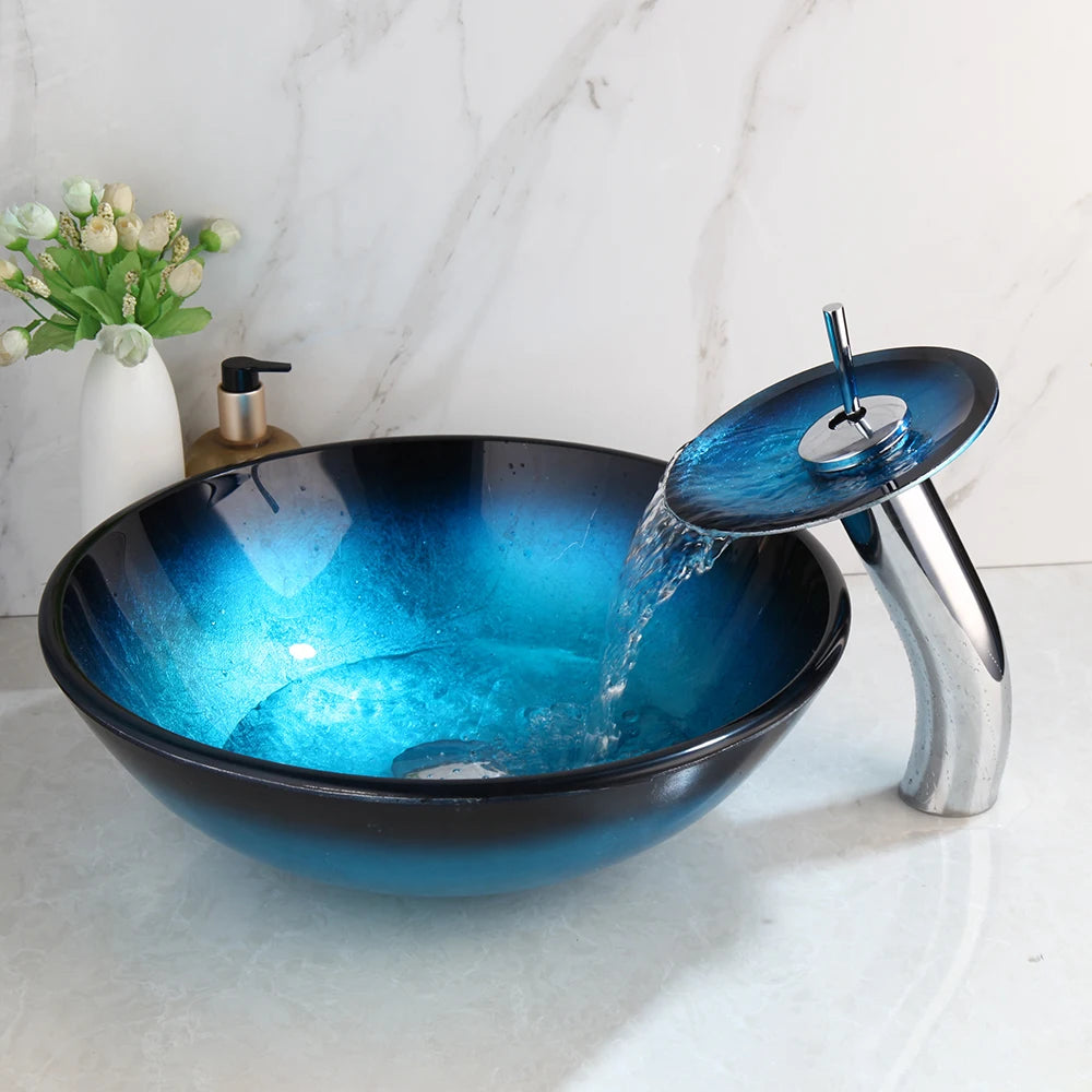Black tempered glass vessel sink with blue oval basin and waterfall faucet, designed for bathroom above-counter installation.