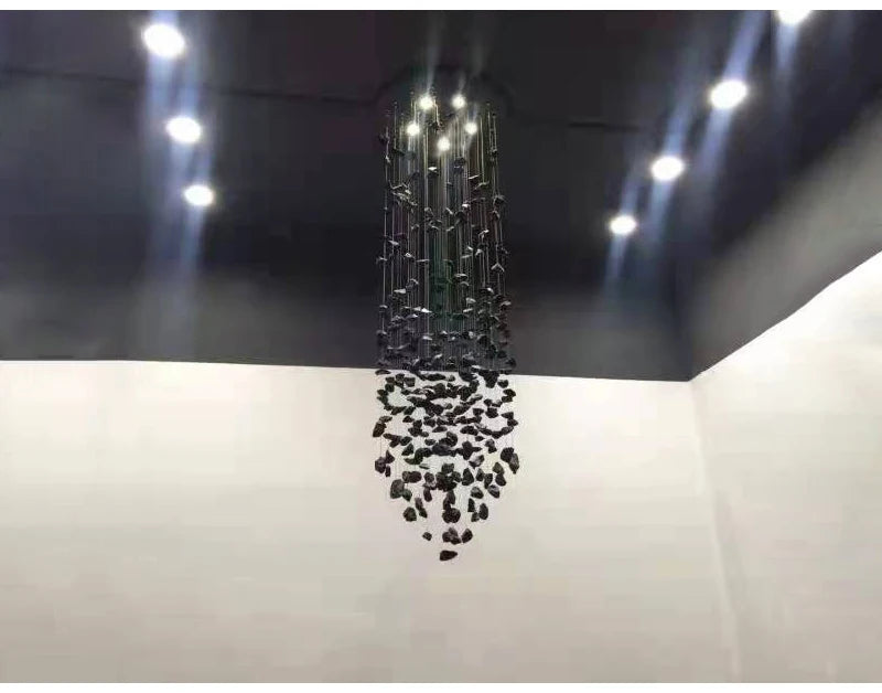 Black Art Luxury Stone Crystal Chandelier by MC THE BLACK DIAMOND hanging in a modern staircase hallway with LED lights and hanging crystals