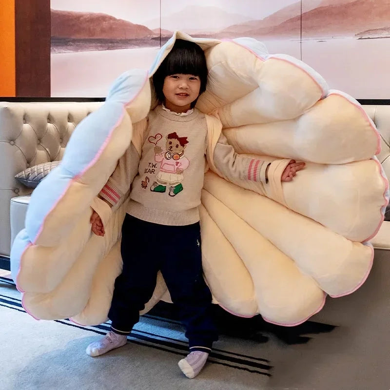 Large clamshell cushion plush pillow shaped like a seashell, designed for kid beds, by MC THE BLACK DIAMOND.