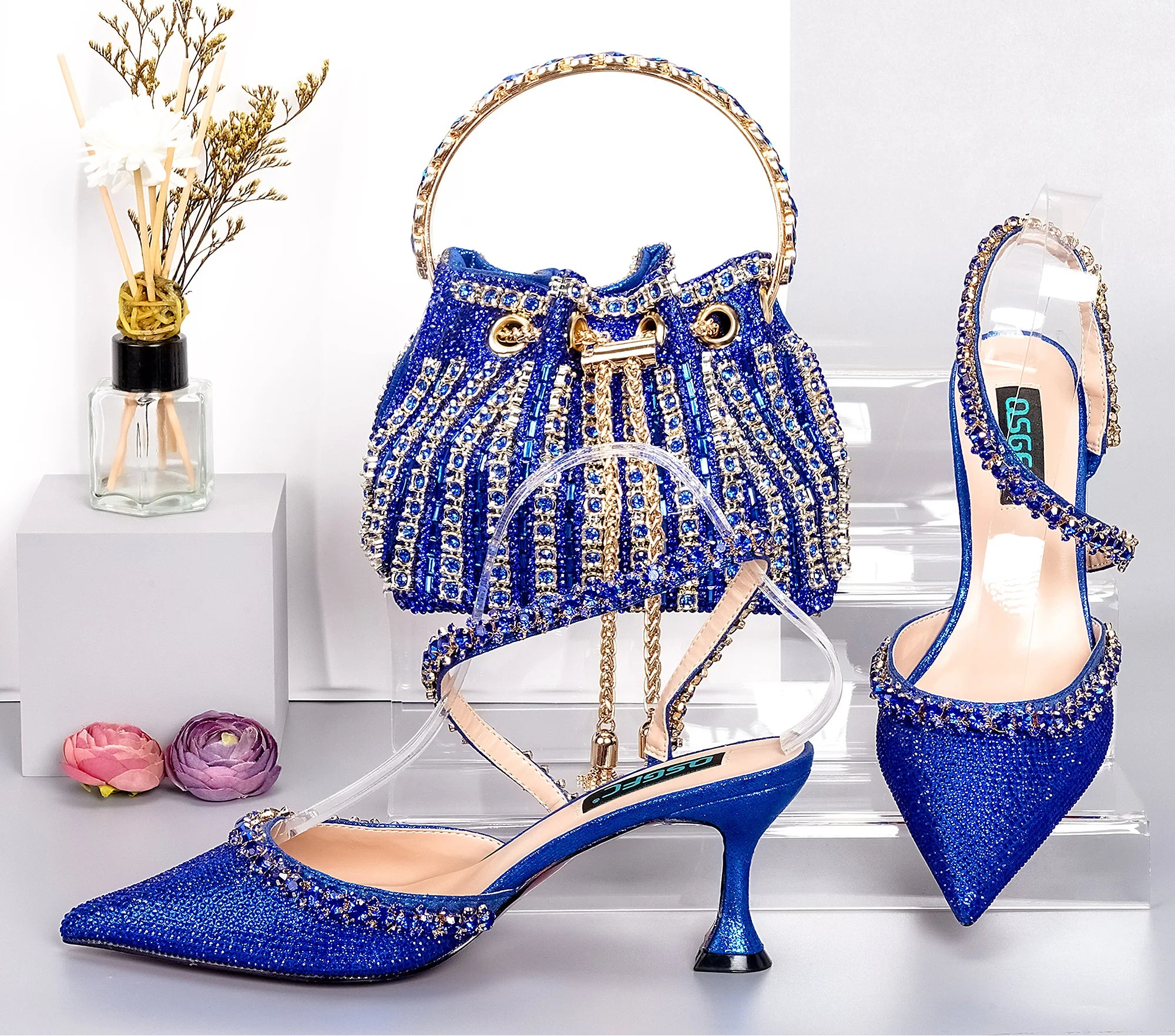 Royal blue MC THE BLACK DIAMOND high heels and matching metallic drill chain bucket bag with elegant design for fashion events.