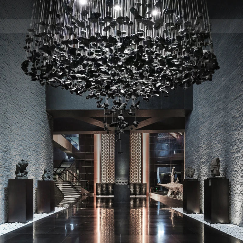 Black Art Luxury Stone Crystal Chandelier by MC THE BLACK DIAMOND with LED lights, hanging in a modern staircase or hallway.