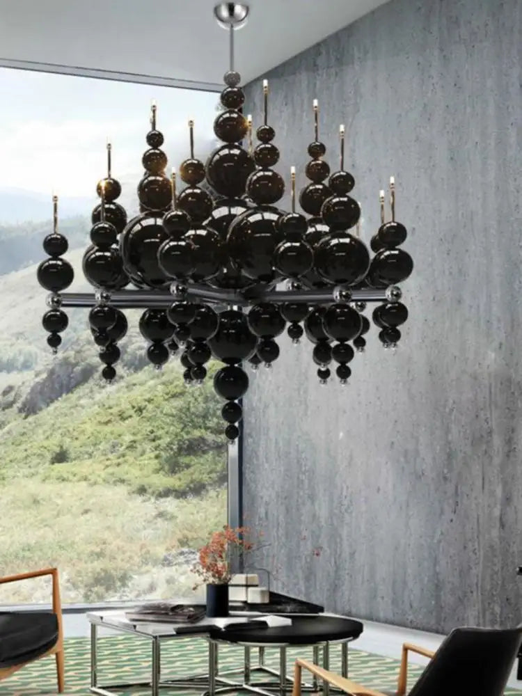Luxury black chandelier by MC THE BLACK DIAMOND hanging from ceiling, featuring tear-shaped design for living room or dining area lighting.