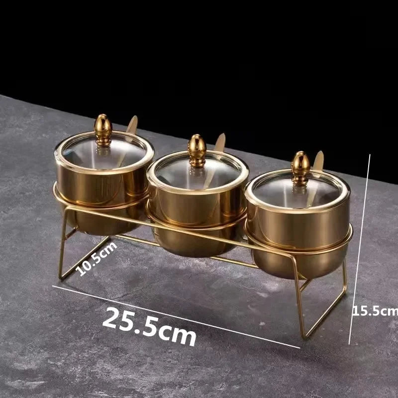 Gold MC THE BLACK DIAMOND seasoning box with glass cap, spoon, and spice jar for salt, soy sauce, and flavoring storage in kitchen.