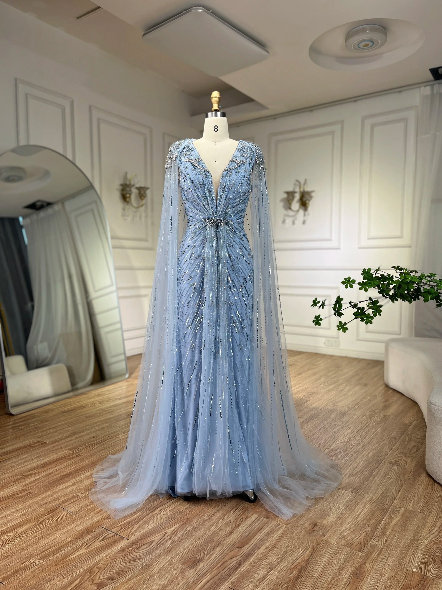 Elegant turquoise mermaid evening dress by MC THE BLACK DIAMOND featuring flowing fabric and a fitted silhouette.