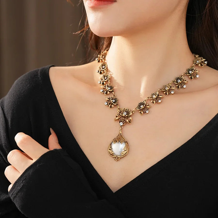 Vintage jewelry set by Mohamad Collection featuring rhinestone flower pendant, pearl earrings, and a high-end retro bride necklace.