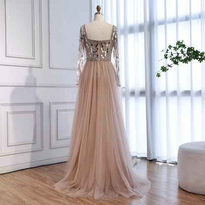 MC Luxury Arabic nude long sleeve mermaid evening dress by MC THE BLACK DIAMOND, fitted with intricate detailing and elegant silhouette.