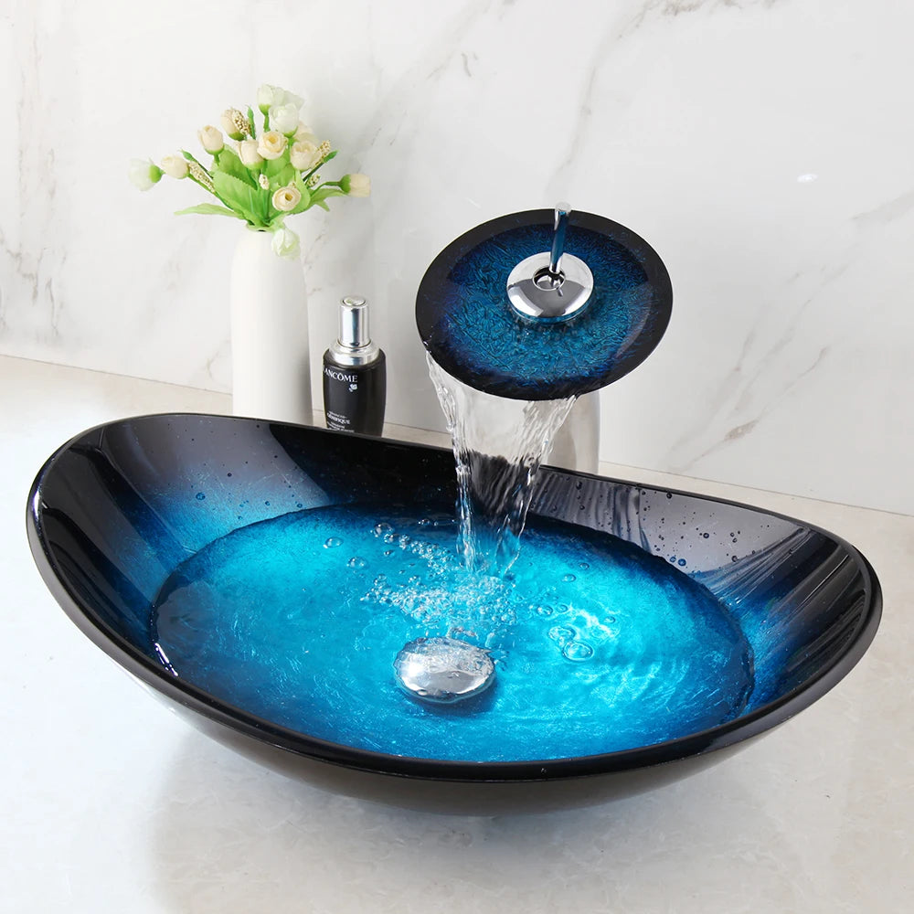 MC THE BLACK DIAMOND ZAPPO tempered glass bathroom vessel sink with waterfall black faucet and oval blue basin, above counter design.