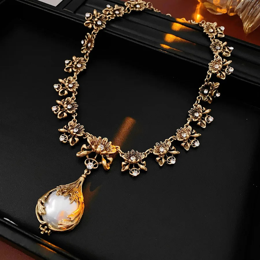Vintage luxury jewelry set with rhinestone inlay, flower pendant, pearl earrings, and high-end necklace from Mohammad Collection.