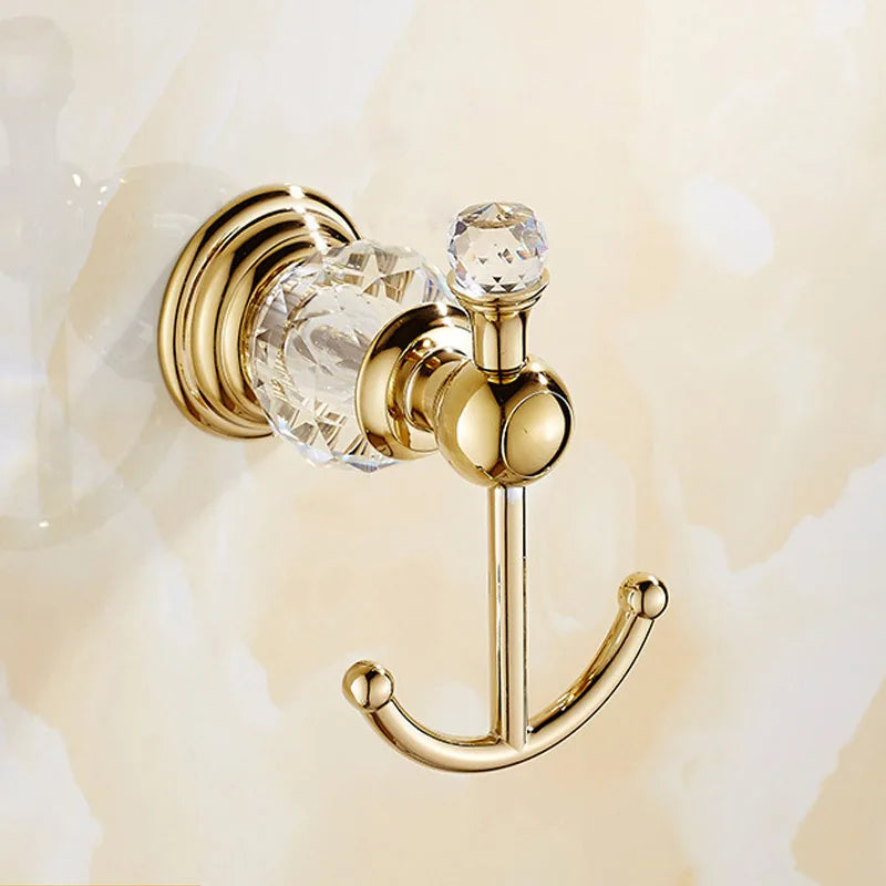 Luxury gold polished brass bathroom accessories set with wall-mounted crystal hardware, including soap dish, towel ring, and robe hook.