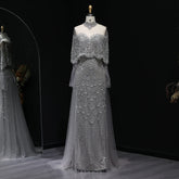 Beaded grey Arabic evening dress by MC THE BLACK DIAMOND featuring intricate beadwork and elegant flowing design.