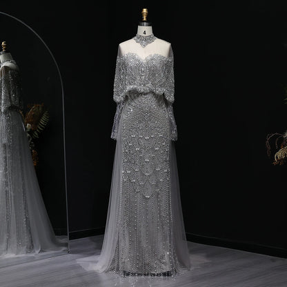 Beaded grey Arabic evening dress by MC THE BLACK DIAMOND featuring intricate beadwork and elegant flowing design.