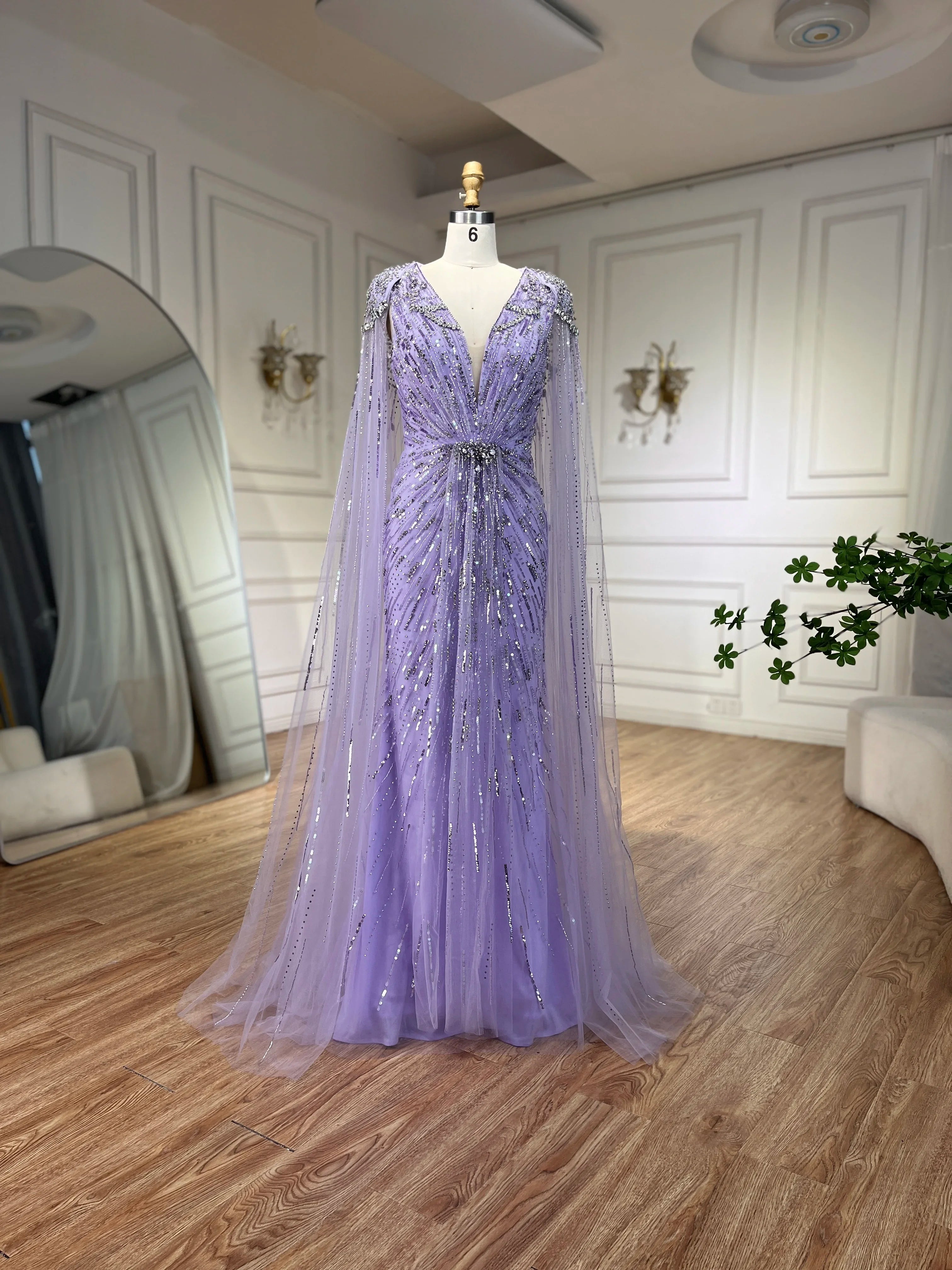 Turquoise mermaid evening dress by MC THE BLACK DIAMOND featuring a fitted silhouette and elegant design, displayed on a mannequin.