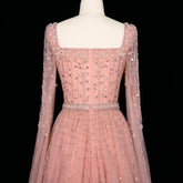 Elegant pink Dubai evening dress by MC THE BLACK DIAMOND, featuring luxurious fabric and intricate design details.