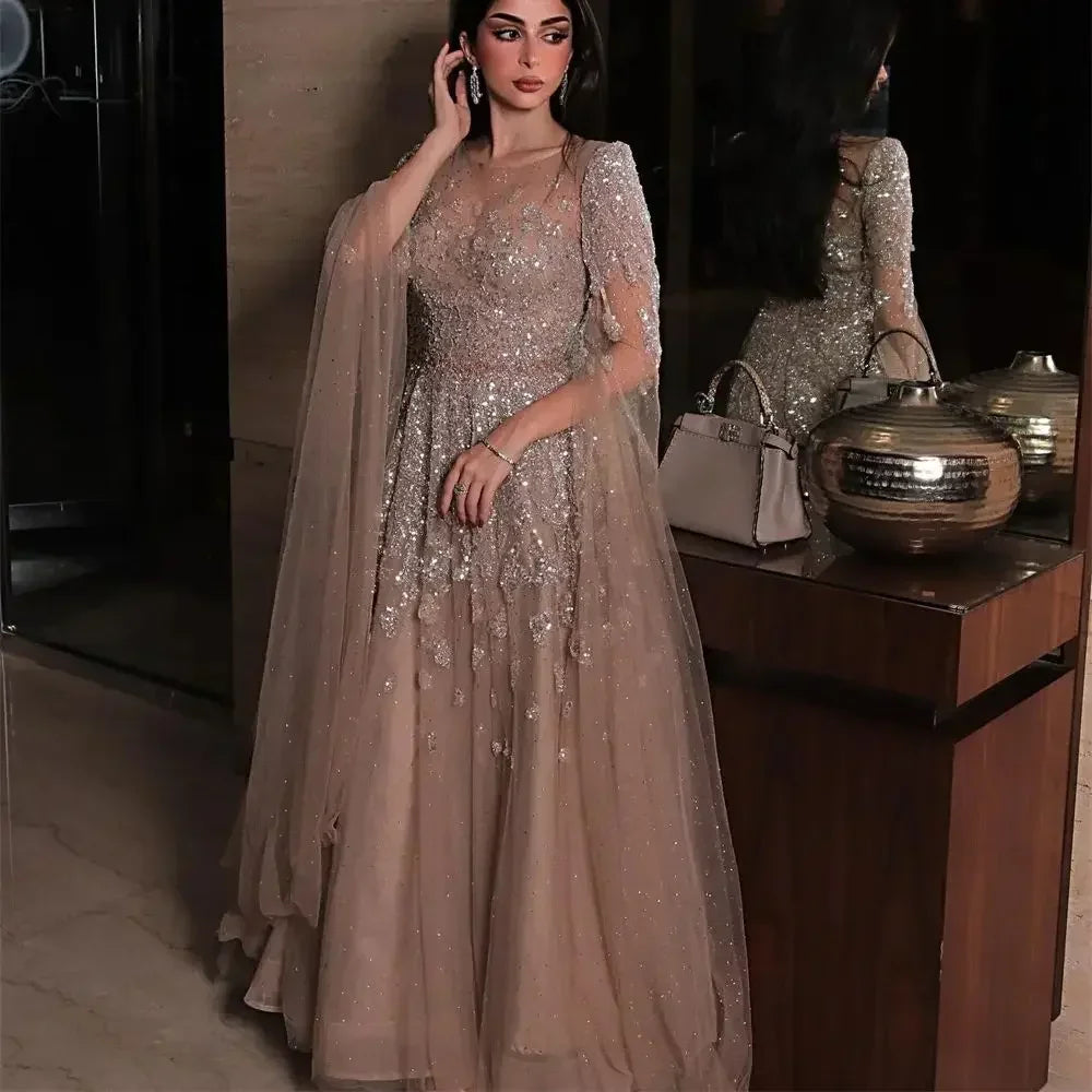 Elegant MC THE BLACK DIAMOND evening gown with batwing sleeves, shiny tulle, sequins, and intricate applique for a glamorous party look.