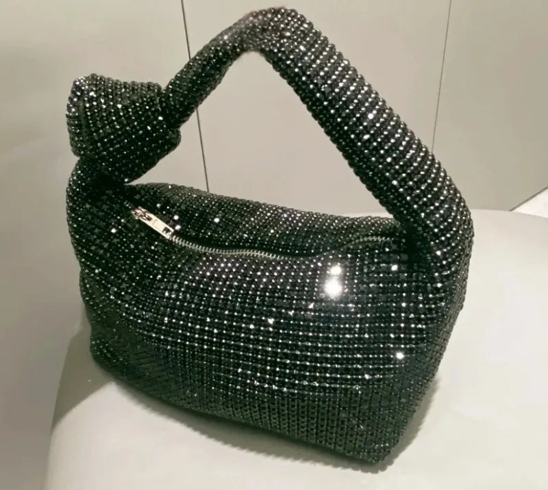 Silver MC THE BLACK DIAMOND evening handle bag with rhinestone knot design, crystal accents, and top handle for women’s luxury purses