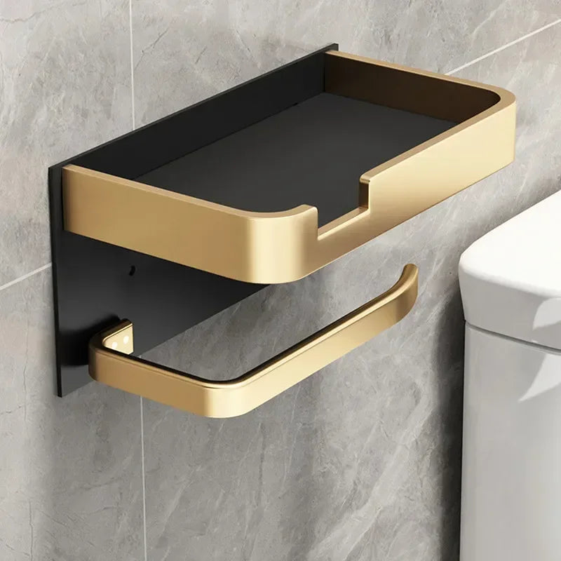 Black gold MC THE BLACK DIAMOND toilet paper holder mounted on a bathroom wall with a roll of toilet paper.