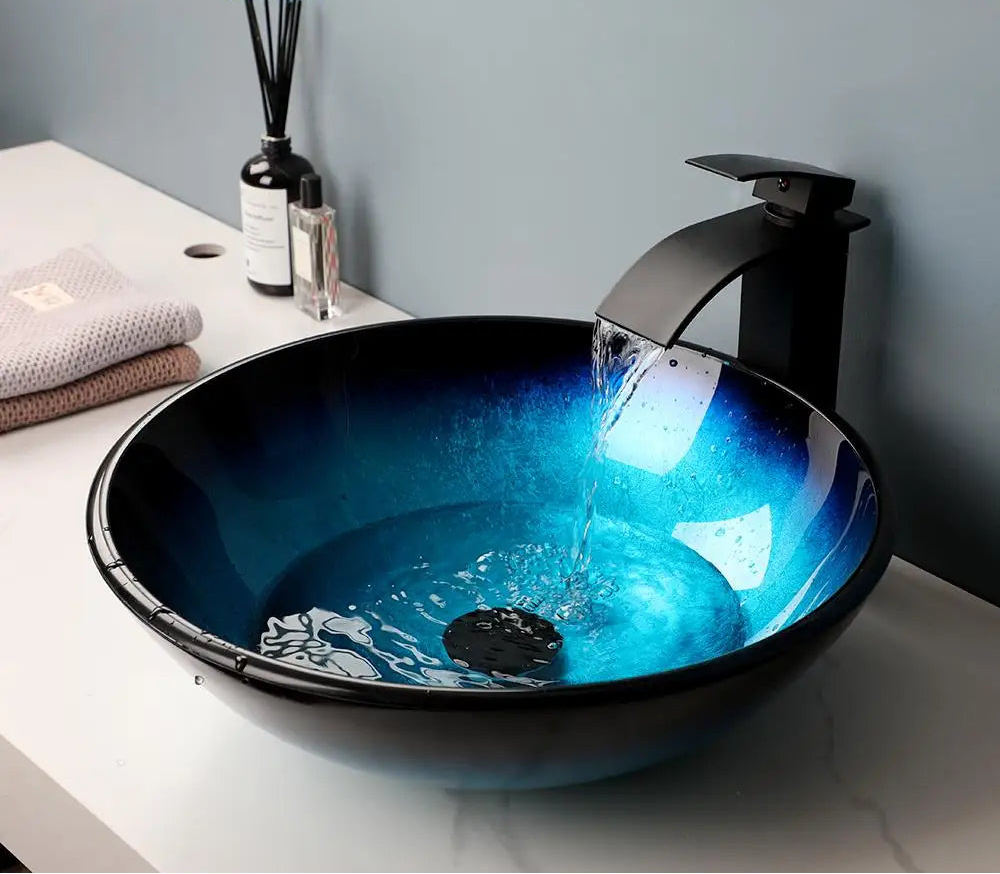 MC THE BLACK DIAMOND ZAPPO tempered glass bathroom vessel sink with waterfall black faucet, oval blue above-counter basin image