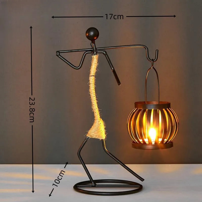 Nordic metal candle holder featuring an abstract character sculpture by 𝕄𝕔 𝕋𝕙𝕖 𝔹𝕝𝕒𝕔𝕜 𝔻𝕚𝕒𝕞𝕠